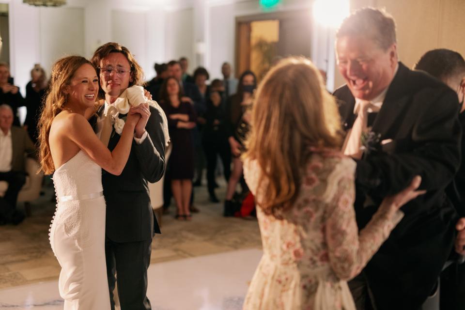 Savannah Boehrer (left) watches as her dad Sam Schmidt dances with her mom Sheila for the first time in 21 years.