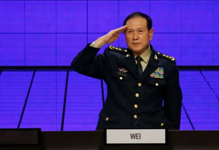 Chinese Defense Minister Wei Fenghe salutes at the IISS Shangri-la Dialogue in Singapore