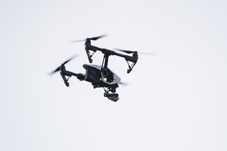 A drone flow by investigator flies over the scene of a small plane crash in a residential neighborhood in Upper Moreland, Pa., Thursday, Aug. 8, 2019. Upper Moreland Police Chief Michael Murphy says the plane hit several trees before it finally came to rest. He said everyone aboard the plane was killed. (AP Photo/Matt Rourke)
