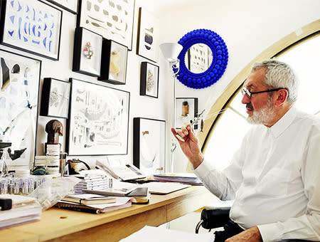 Christian Astuguevieille has worn many hats. Now, he's the nose behind scents made by the Japanese fashion house Comme des Garçons. Notice the many vials to the left of his desk.