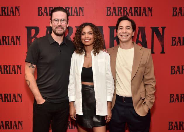 Director Zach Cregger poses alongside actors Georgina Campbell and Justin Long at a screening of