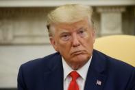 U.S. President Trump answers questions from the news media in the Oval Office of the White House in Washington