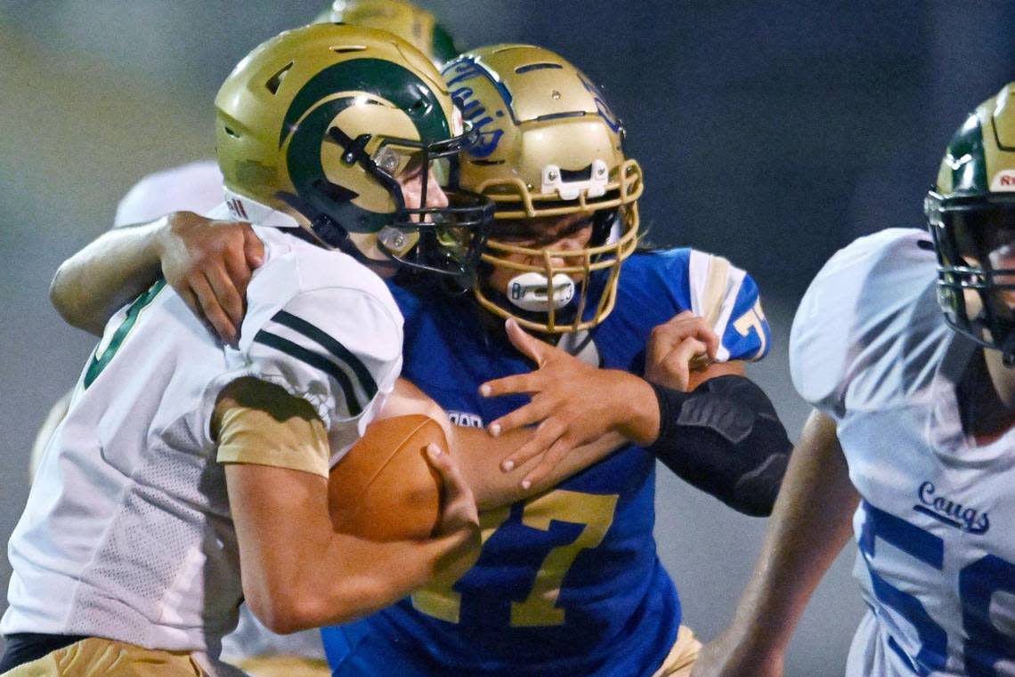 Clovis High’s Logan Cordero, right, sacks Garces quarterback Gunter Golla, left, Thursday, Aug. 17, 2023 in Clovis. ERIC PAUL ZAMORA/ezamora@fresnobee.com