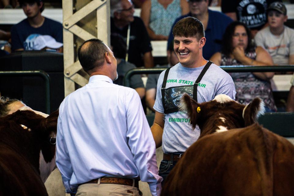Grant Brix talks with a judge during the 4-H Beef Cattle Show at the Iowa State Fair.