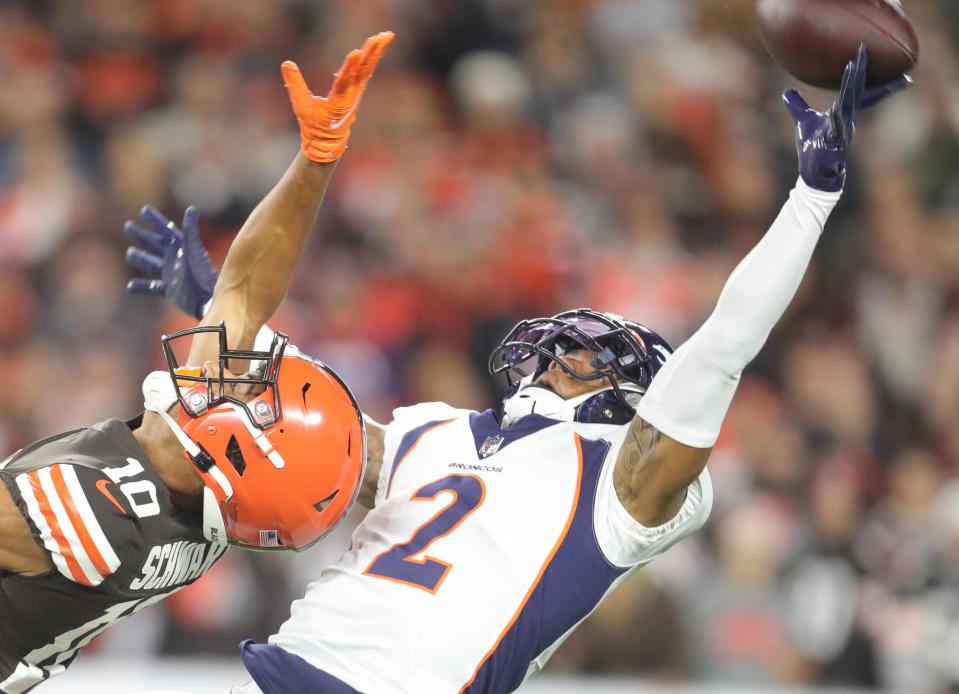 Cleveland Browns' Anthony Schwartz can't get to a deep ball as Denver Broncos' Par Surtain II defends on Thursday, Oct. 21, 2021 in Cleveland, Ohio, at FirstEnergy Stadium. [Phil Masturzo/ Beacon Journal]