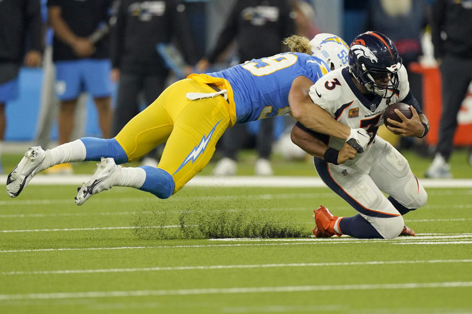 Los Angeles Chargers linebacker Kenneth Murray Jr. (9) tackles Denver Broncos quarterback Russell Wilson (3) during the second half of an NFL football game, Monday, Oct. 17, 2022, in Inglewood, Calif. (AP Photo/Mark J. Terrill)