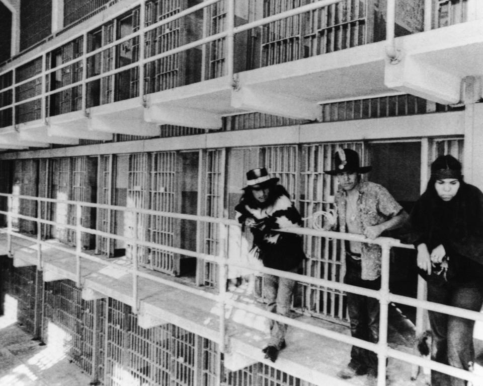 A group of Native Americans look over the main cell block of Alcatraz in San Francisco, Nov. 19, 1969, after occupying the island for the second time in two weeks.