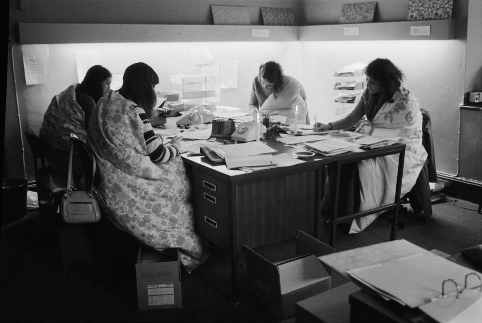 Four women working in an office in Bond Street, London during the power cuts of 1973-74, which were caused by the miners' strike. Luckily for these women, the cold is not a problem, as they work for Slumberdown and are able to wrap themselves in Slumberdown continental quilts to keep warm.   (Photo by Evening Standard/Getty Images)