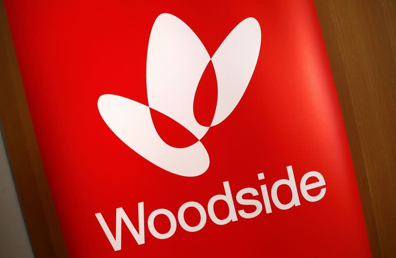 FILE PHOTO: The logo for Woodside Petroleum, Australia's top independent oil and gas company, adorns a promotional poster on display at a briefing for investors in Sydney