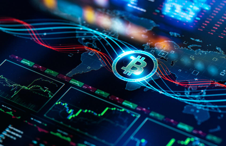 Bitcoin logo on top of map and chart.