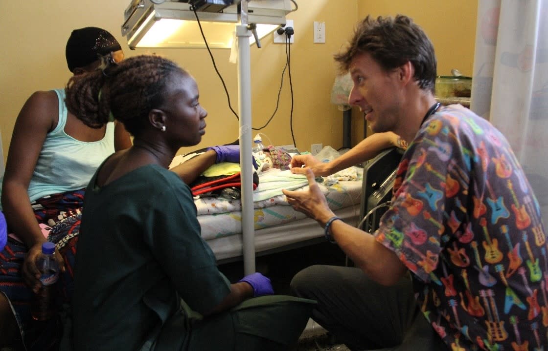 Mr Bryant with patients at ELWA Hospital in Liberia. (Swansea Bay UHB/Mikey Bryant)