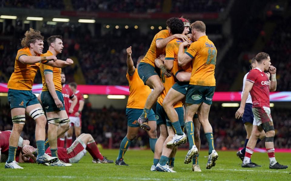 Australia celebrate their remarkable victory over a shellshocked Wales in Cardiff - Joe Giddens /PA