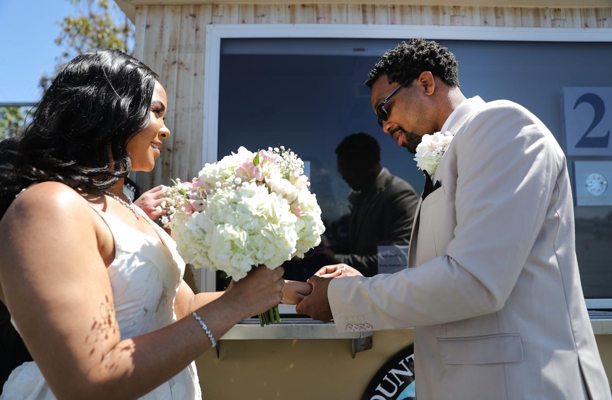 Rodney and Monica Cosby exchange rings May 19, 2020 in Anaheim, California. The Orange County Clerk-Recorder opened a pop-up, socially distanced marriage booth in the parking lot of the city's Honda Center, home to the Anaheim Ducks.