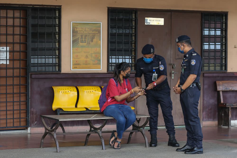 KTM auxiliary police personnel conduct checks on KTM passengers in Shah Alam amid the movement control order June 8, 2021. — Picture by Yusof Mat Isa