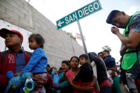 Members of a migrant caravan from Central America line up to receive breakfast at the end of their journey through Mexico, prior to preparations for an asylum request in the U.S., at a shelter in Tijuana, Baja California state, Mexico April 27, 2018. REUTERS/Edgard Garrido