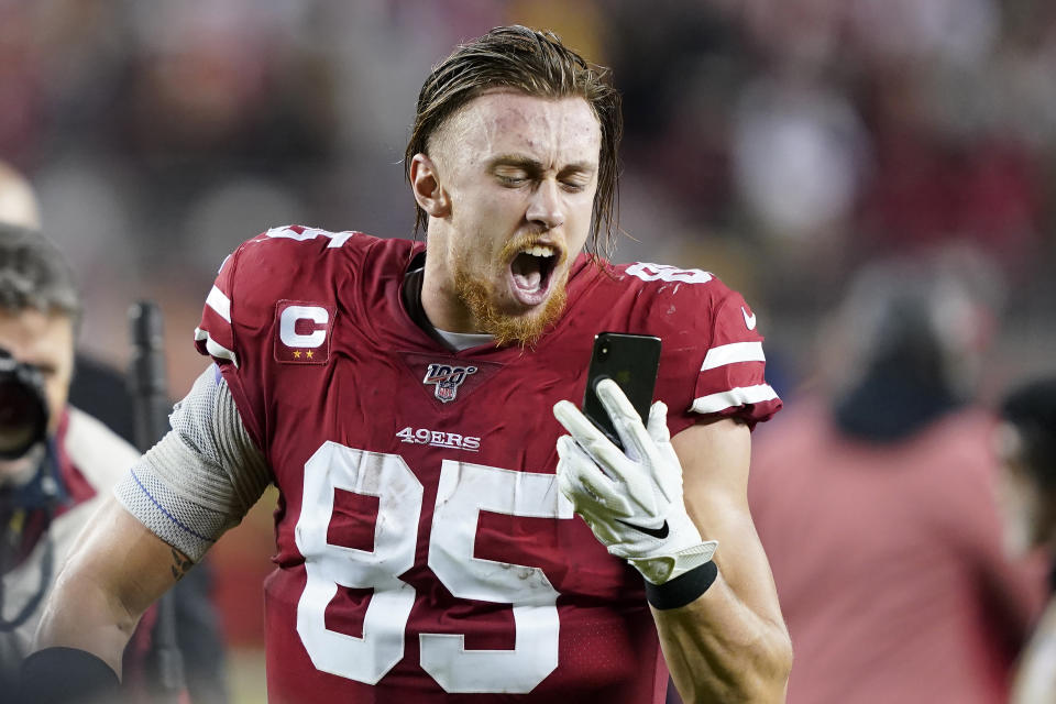 San Francisco 49ers tight end George Kittle yells into a phone while celebrating after the 49ers defeated the Los Angeles Rams in an NFL football game in Santa Clara, Calif., Saturday, Dec. 21, 2019. (AP Photo/Tony Avelar)