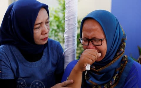 Women, who are relatives of passengers on the crashed Lion Air flight JT610, cry at Bhayangkara R. Said Sukanto hospital in Jakarta - Credit: Reuters