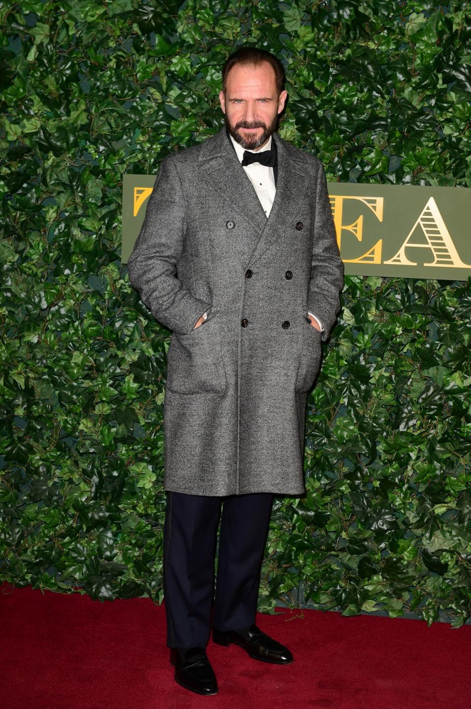 <p>Ralph Fiennes looked ever the gentleman in a grey coat buttoned over a smart black suit. <i>[Photo: PA]</i> </p>