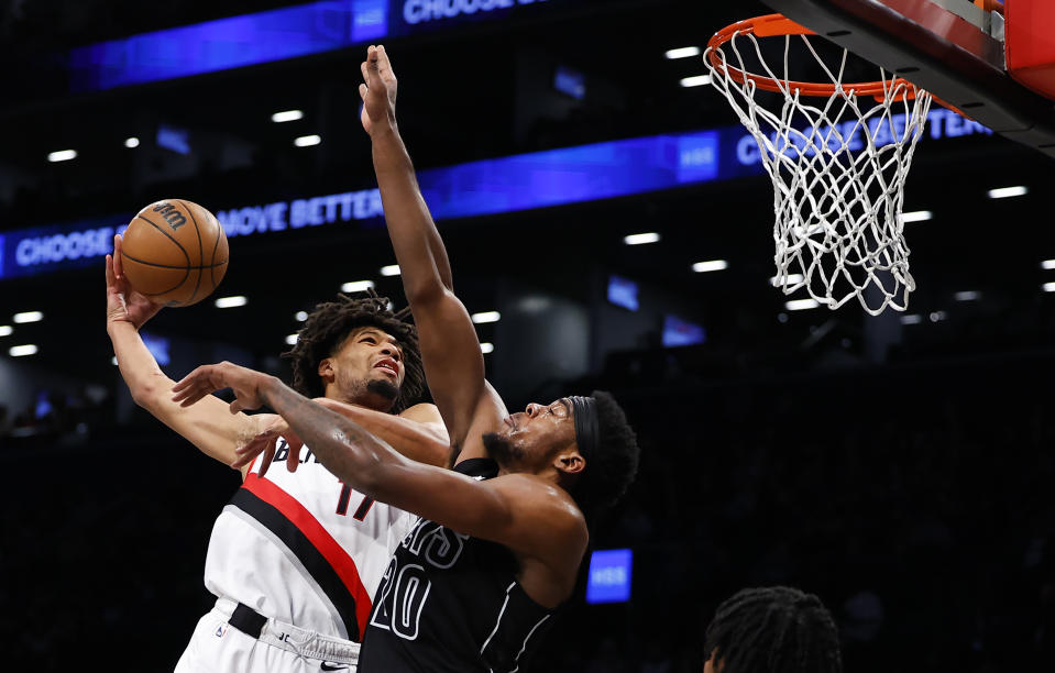 Portland Trail Blazers guard Shaedon Sharpe (17) drives to the basket against Brooklyn Nets center Day'Ron Sharpe (20) during the first half of an NBA basketball game, Sunday, Jan 7, 2024, in New York. (AP Photo/Noah K. Murray)