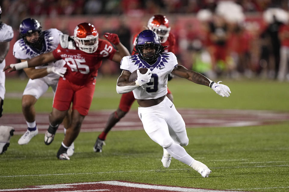 TCU running back Emani Bailey (9) runs for a first down against Houston during the first half of an NCAA college football game Saturday, Sept. 16, 2023, in Houston. (AP Photo/David J. Phillip)