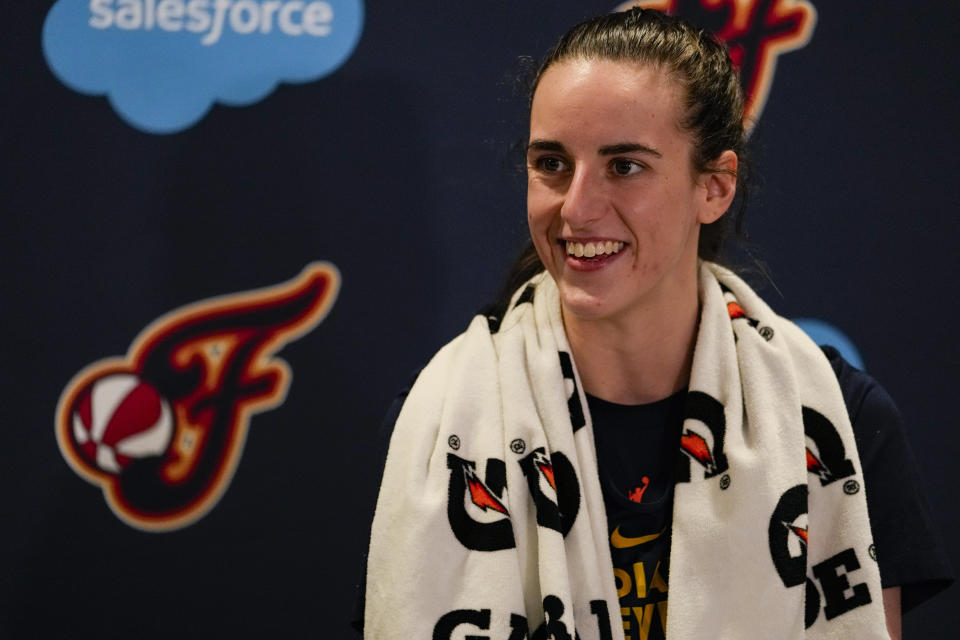 Indiana Fever guard Caitlin Clark speaks with the media after the WNBA basketball team practiced in Indianapolis, Sunday, April 28, 2024. (AP Photo/Michael Conroy)