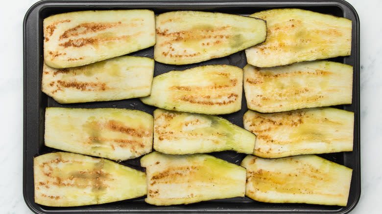 sliced eggplants on baking sheet