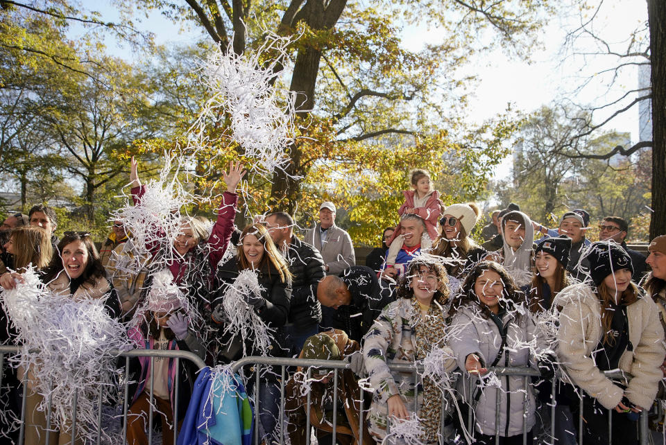 Spectators toss confetti as the parade makes its way down Central Park Avenue West during the Macy's Thanksgiving Day Parade, Thursday, Nov. 24, 2022, in New York. (AP Photo/Julia Nikhinson)