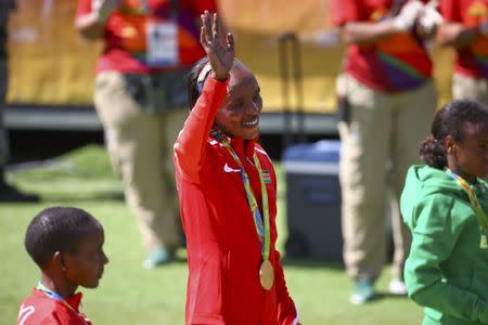 2016 Rio Olympics - Athletics - Victory Ceremony - Women's Marathon Victory Ceremony - Sambodromo - Rio de Janeiro, Brazil - 14/08/2016. Gold medallist Jemima Sumgong (KEN) of Kenya waves. REUTERS/David Gray