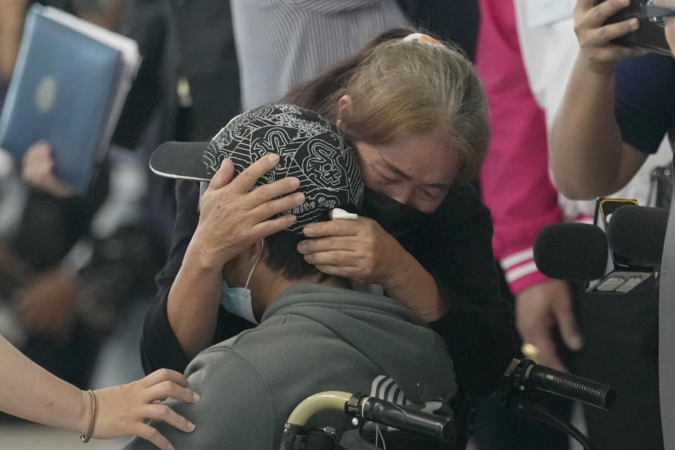 A relative hugs a Thai overseas worker who was evacuated from Israel, on his arrival at Suvarnabhumi International Airport in Samut Prakarn Province, Thailand, Thursday, Oct. 12, 2023. The first Thai nationals evacuated since the latest war between Israel and Hamas returned home Thursday. (AP Photo/Sakchai Lalit)