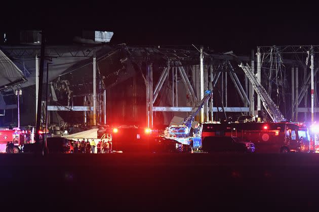 First responders surround a heavily damaged Amazon Distribution Center in Edwardsville, Illinois, Friday night after the building partially collapsed when violent storms, including a tornado, ripped through the area. (Photo: Michael Thomas via Getty Images)