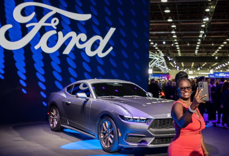 Nortrice Banner, actress and comedian from Detroit, takes a selfie in front of a Ford Mustang during the 2022 North American International Auto Show Charity Preview at Huntington Place in Detroit on Friday, Sept. 16, 2022.