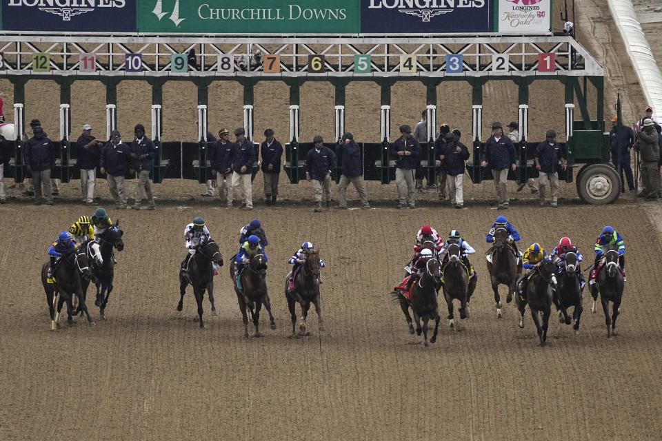 Riders head down the front stretch during the start of the 148th running of the Kentucky Oaks horse race at Churchill Downs on Friday, May 6, 2022, in Louisville, Ky. (AP Photo/Charlie Riedel)