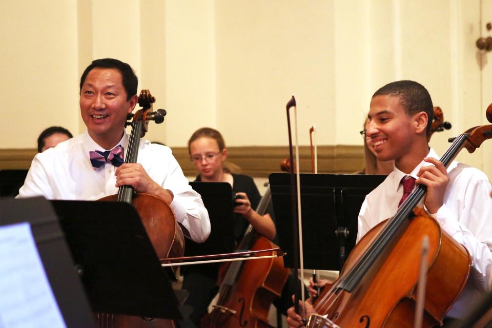 University of Cincinnati president Santa Ono performs with the Cincinnati Young Artistic Cello Choir at Music Hall.