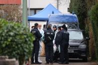 Police officers are seen outside the house of the suspected gunman, following a shooting in Hanau