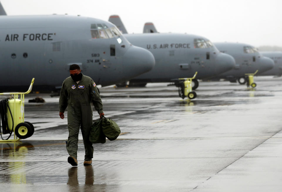 A U.S. soldier wearing a protective face cover is seen in front of C-130 transport planes during a military drill amid the coronavirus disease (COVID-19) outbreak, at Yokota U.S. Air Force Base in Fussa, on the outskirts of Tokyo, Japan May 21, 2020.  REUTERS/Issei Kato