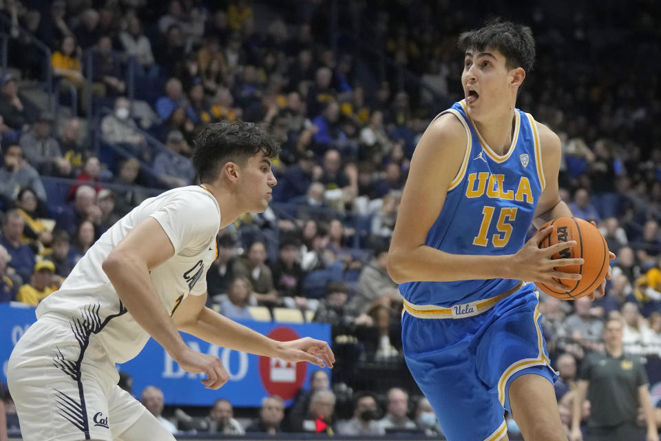 UCLA center Aday Mara (15) drives to the basket against California guard Gus Larson during the second half of an NCAA college basketball game in Berkeley, Calif., Saturday, Feb. 10, 2024. (AP Photo/Jeff Chiu)