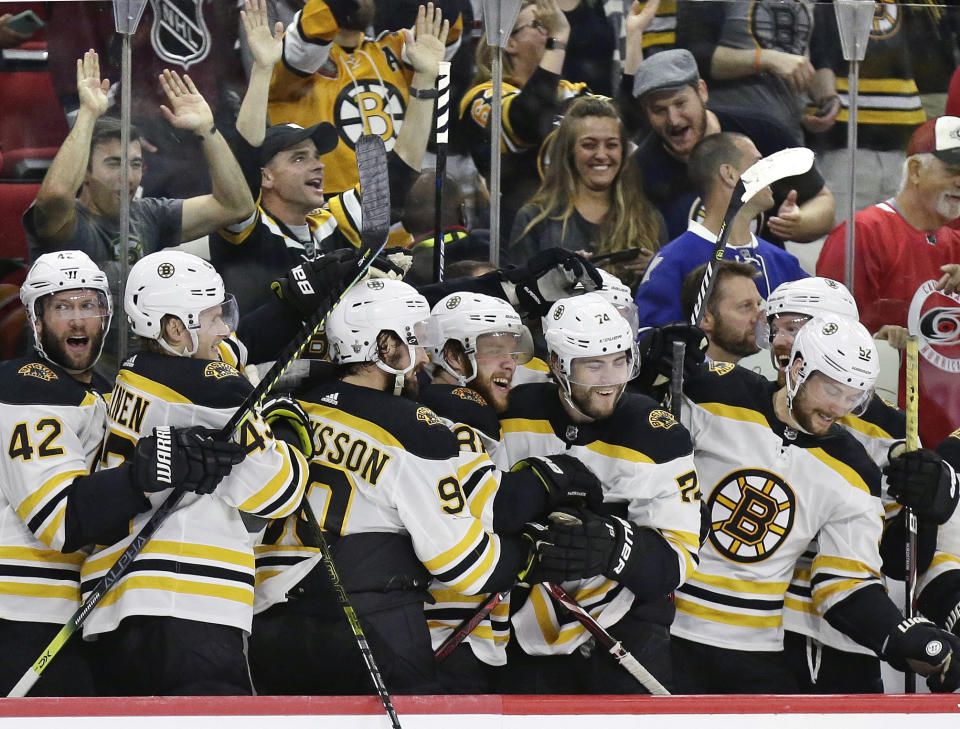 FILE - In this May 16, 2019, file photo, Boston Bruins players celebrate during the closing moments in Game 4 of the team's NHL hockey Stanley Cup Eastern Conference final victory over against the Carolina Hurricanes in Raleigh, N.C. The Bruins will face the St. Louis Blues in Game 1 of the Stanley Cup Final on Monday, May 27, 2019, in Boston. (AP Photo/Gerry Broome, File)