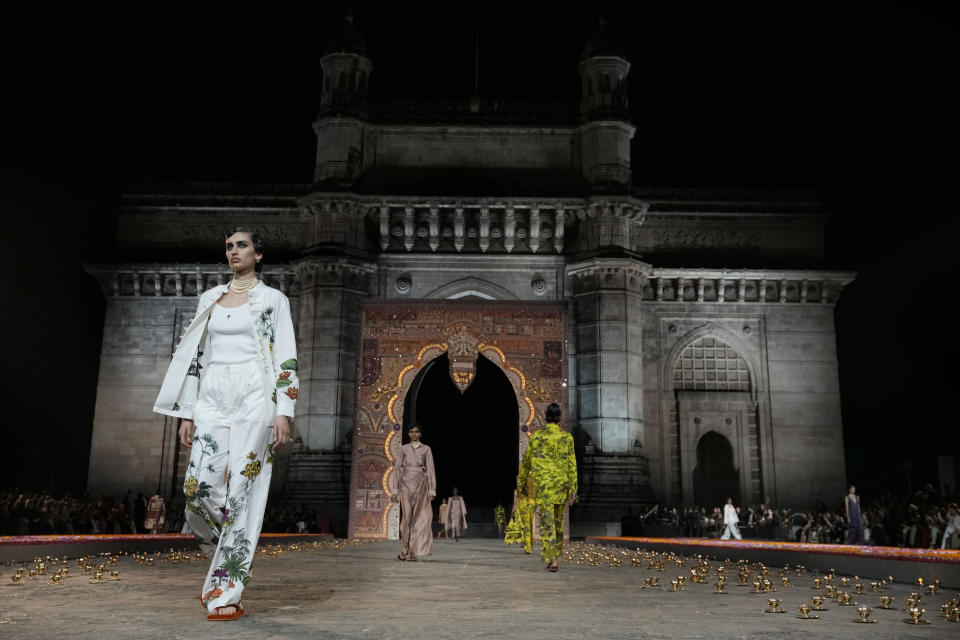 Models display creations for the Dior Pre-Fall 2023 collection at the Gateway of India landmark monument in Mumbai, India, Thursday, March 30, 2023. (AP Photo/Rafiq Maqbool)