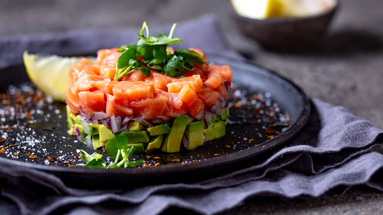 Salmon tartare on dark plate