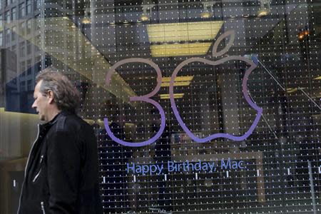 A sign advertising the 30th anniversary of the Macintosh computer is shown at the Apple flagship retail store in San Francisco, California January 27, 2014. REUTERS/Robert Galbraith