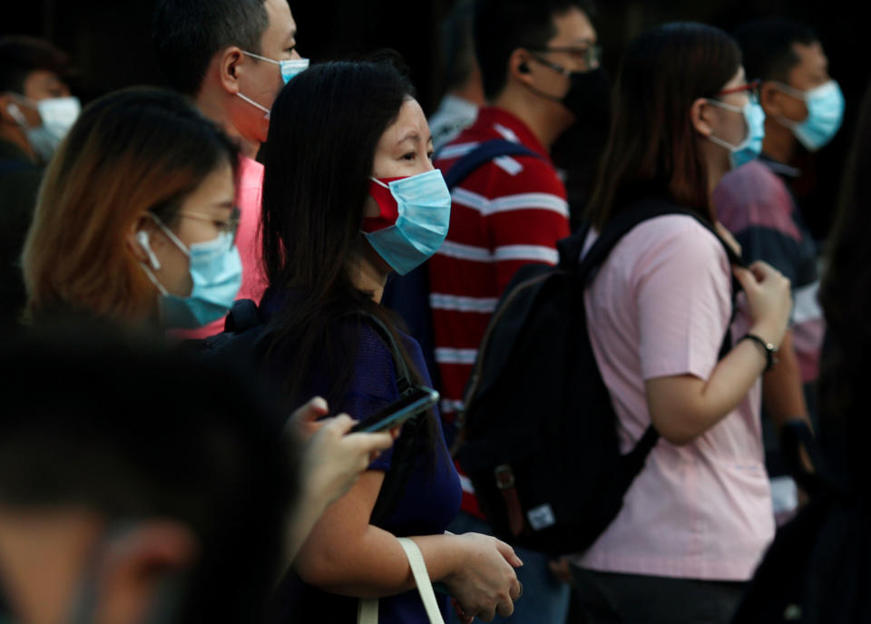 People cross a street during morning peak hour commute amid the coronavirus disease outbreak in Singapore on 3 June, 2020. (PHOTO: Reuters)