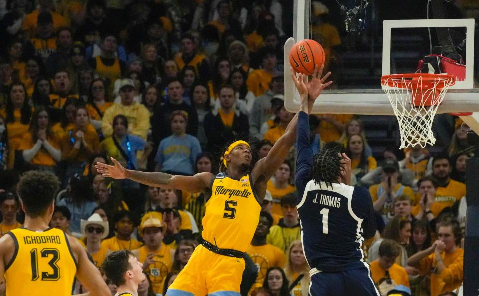 Marquette guard Chase Ross leaps to deflect the ball away from Butler's Jalen Thomas in the first half on Saturday.