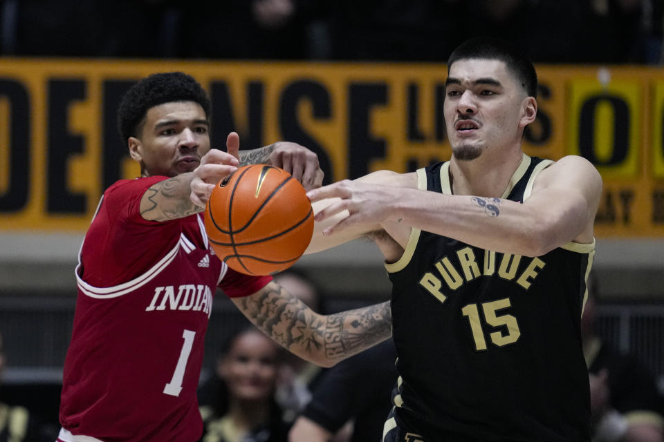 Purdue center Zach Edey (15) and Indiana center Kel'el Ware (1) go for the ball during the first half of an NCAA college basketball game in West Lafayette, Ind., Saturday, Feb. 10, 2024. (AP Photo/Michael Conroy)