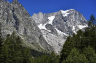 The Planpincieux glacier, located in the Alps on the Grande Jorasses peak of the Mont Blanc massif, is seen from Val Ferret, a popular hiking area on the south side of the Mont Blanc, near Courmayeur, northern Italy, Friday, Aug. 7, 2020. Some 70 people were evacuated Thursday in the valley below the glacier and roads closed after the threat of collapse the the fast-moving melting glacier is posing to the picturesque valley near the Alpine town of Courmayeur. (Claudio Furlan/LaPresse via AP)