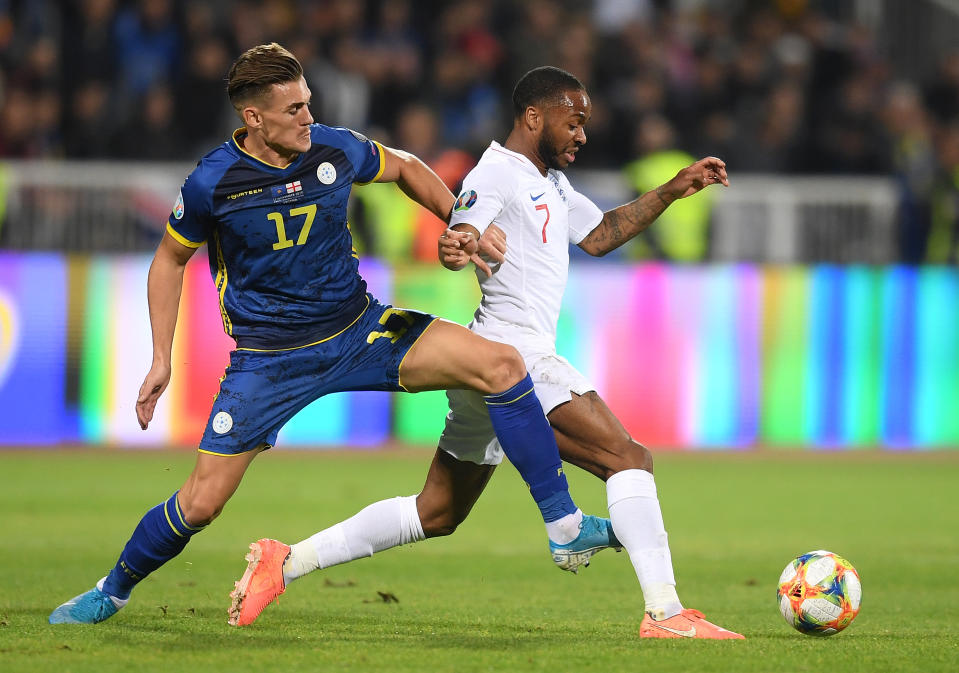 PRISTINA, KOSOVO - NOVEMBER 17: Benjamin Kololli of Kosovo tackles Raheem Sterling of England  during the UEFA Euro 2020 Qualifier between Kosovo and England at the Pristina City Stadium on November 17, 2019 in Pristina, Kosovo. (Photo by Michael Regan/Getty Images)