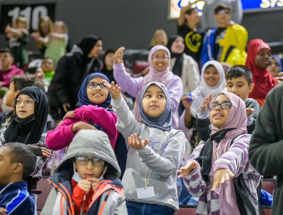 Students from the Daarul Uloom Islamic School do the "Macarena" during the Peoria Rivermen/Quad City Storm hockey game Thursday, Dec. 15, 2022 at Carver Arena.