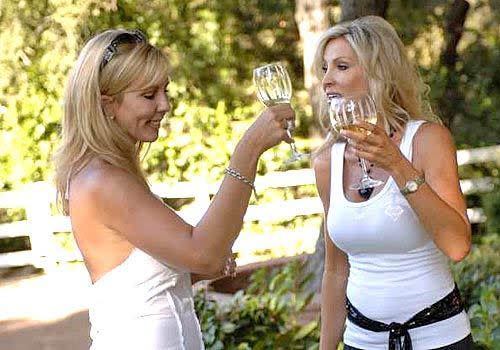 Vicki Gunvalson, left, with Lauri Waring, who lives in a “town home” and yearns to get back to her former life behind the gates of Orange County's Coto de Caza community.