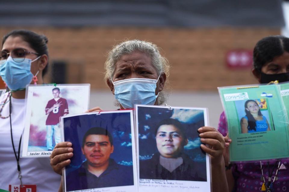 Members of a caravan of Central American mothers hold photos of their missing children during a demonstration at the Zocalo in México City, on May 7, 2022. The protesters, made up mostly of women from Central America, travel through México to search for their relatives who left for a better life and then disappeared on their way to the U.S.