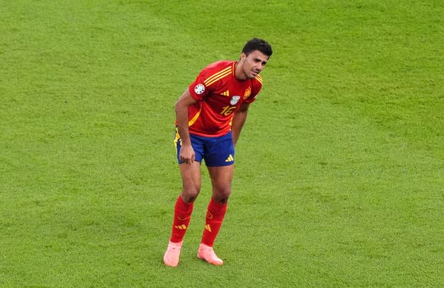 Spain’s Rodri holds his leg at half-time