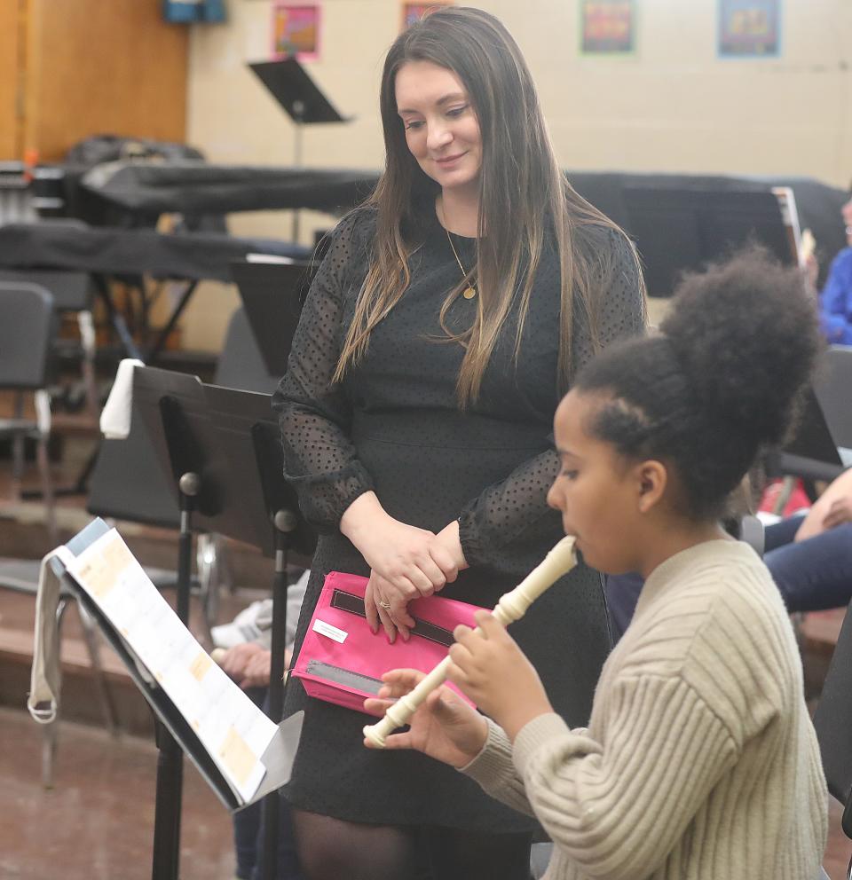 Miller South music teacher Marissa Hughes watches fifth grade student Bella Morris play the recorder.
